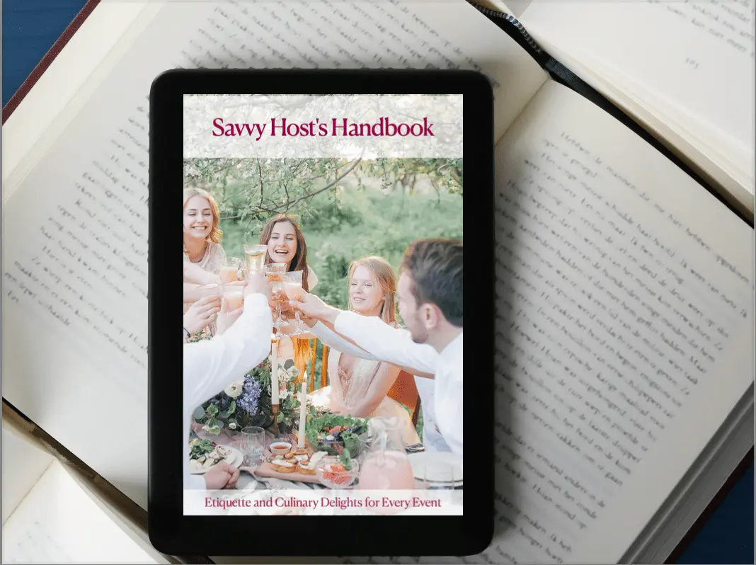 A tablet showing the cover of "Savvy Host's Handbook," featuring a stylish outdoor meal scene with people toasting, representing an elegant lifestyle and event hosting